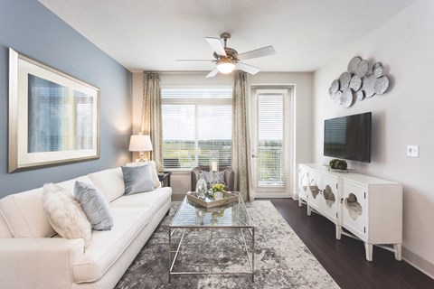 an open living room with a white couch and a tv
